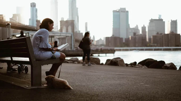 No matter which country we are from and what those around us believe, we as Christians need to look to God’s expectations for us—and these are found in the Bible. A woman sitting on a bench reading.