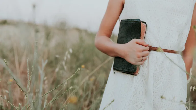 How Can You Preach the Gospel? Girl holding a Bible in a field