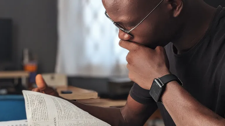 Even after our initial washing from sin at baptism, God expects us to continue to work at overcoming. a man reading a Bible