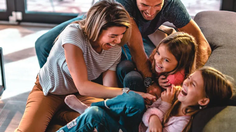 Our Creator established the divine institution of marriage and family so that human beings could learn to love one another as He loves them! A family playing together.
