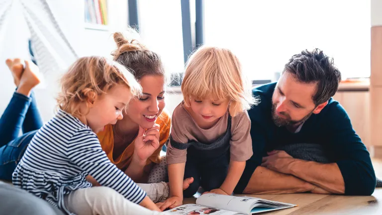 A family looking at a book.