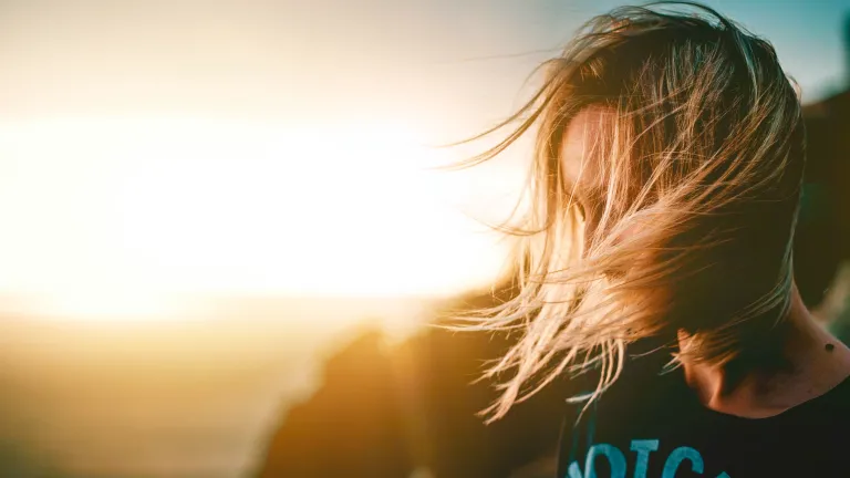 A woman looking to the ground.