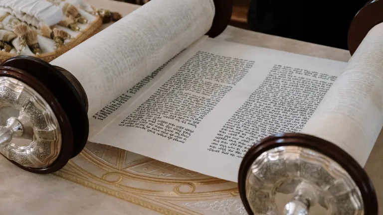 a Hebrew scroll rolled partially open to reveal text