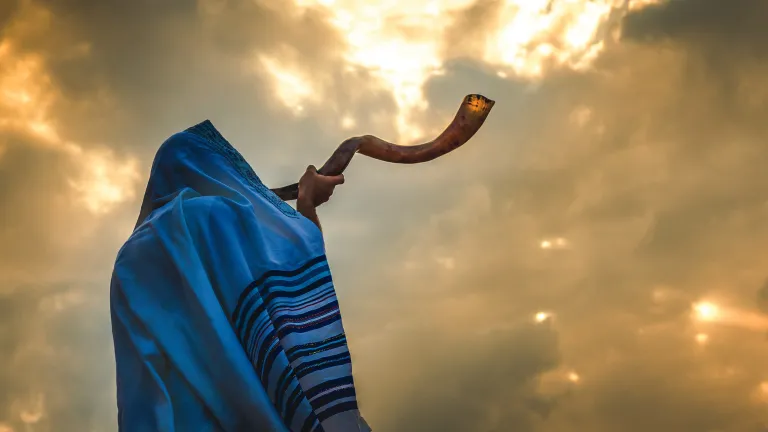 God used the sound of a blown trumpet to signal His Feast of Trumpets, which pictures the return of Jesus Christ at “the last trumpet.” A person blowing a shofar.