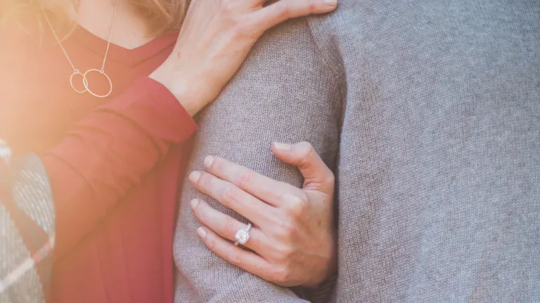 a woman's arm linked through a man's arm