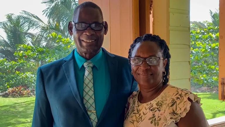 a smiling couple wearing church attire