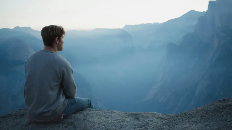 To meditate entails thinking deeply and carefully about Scripture, trying to better understand God’s underlying intentions for His commands, why these precepts are important and how to apply them to our lives. A young man sitting on rock looking out over a valley.