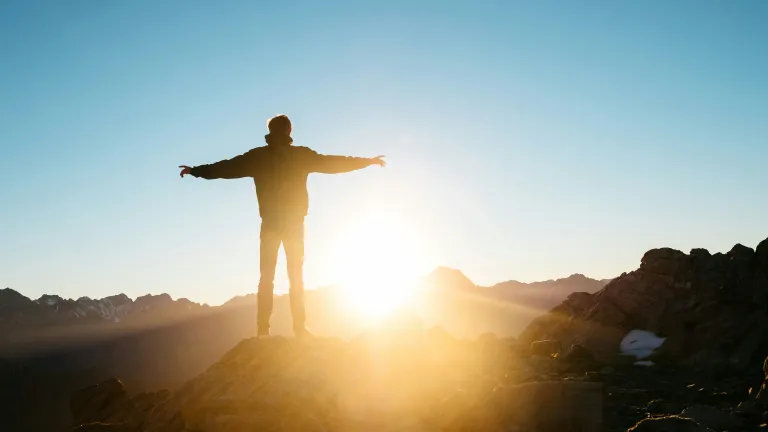 What’s the remedy for human nature? It’s to “be transformed” spiritually (Romans 12:1-2). A person with the arms extended.