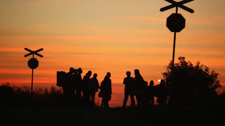 While migrant admittance is legally justifiable in cases of genuine need for asylum, most are coming for economic benefit. And then there are those who may intend harm. Silhouette of people standing at a railroad creossing.