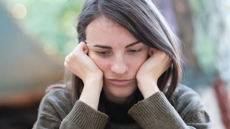 God will never let us down if we fully trust and obey Him. He will give us the spiritual, mental and emotional strength we need to face and conquer our fears and anxieties. A woman resting her head on her hands.