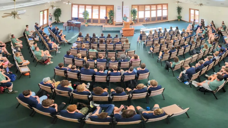 Camp Pinecrest a large group of people seated in a semicircle indoors
