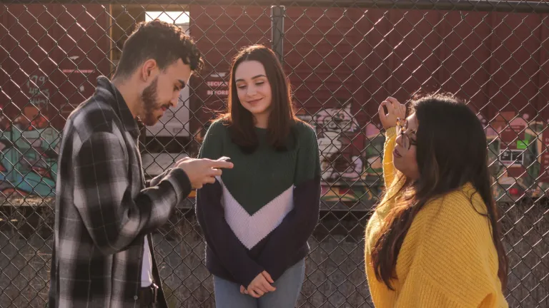 While being politically correct will put you in a generally comfortable place with your professors and peers, it will slowly take you away from biblical values. a man and two women standing outdoors in front of a wire fence