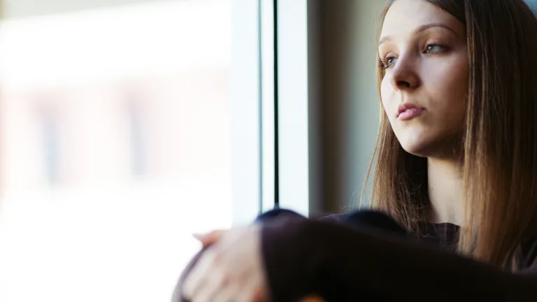 A young woman sitting by herself.