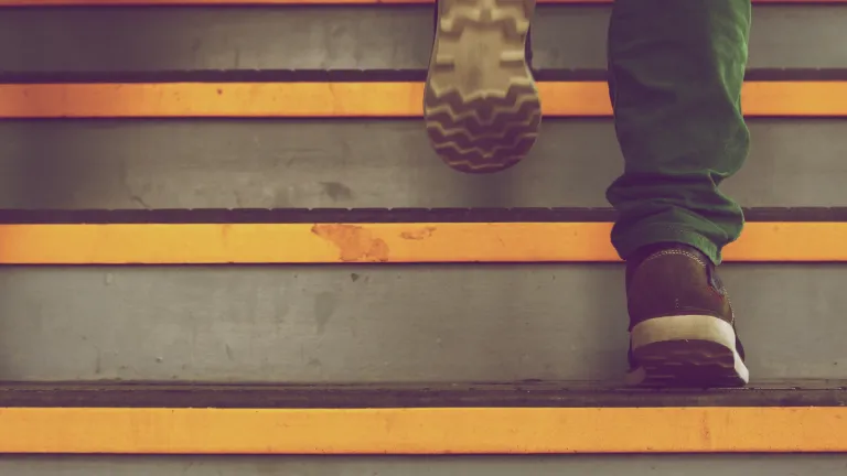 The primary secret to the longstanding record of success of the Twelve Step program lies in the fact that these steps, learned from the bitter road of experience, have been in the Bible long before they were realized and formulated in A.A. A person walking up stairs.