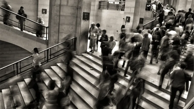A blur of people walking in a building.