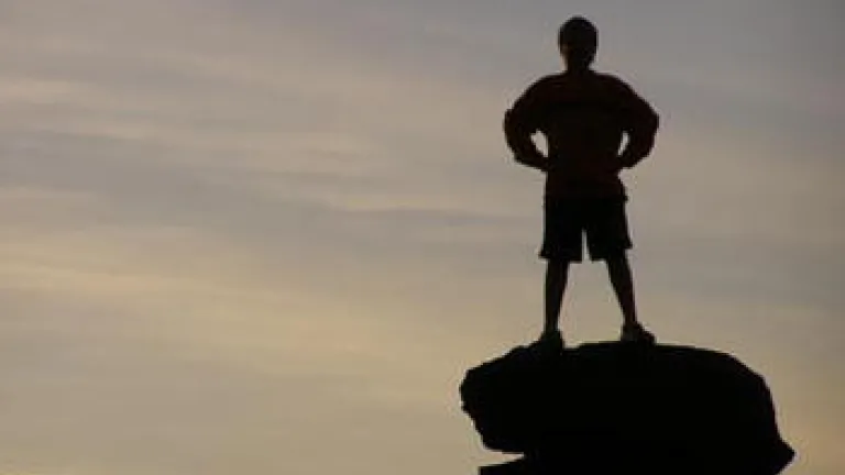 boy standing on a rock