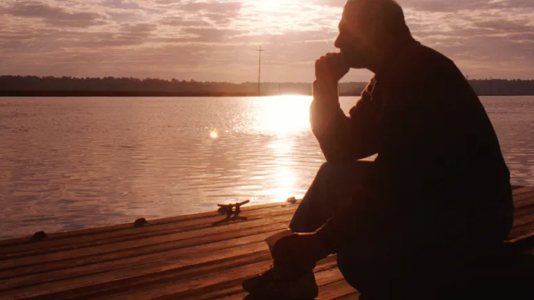 A older man sitting and thinking.