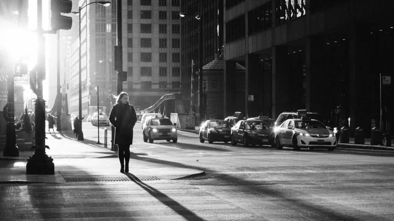 A woman walking on a busy city street.