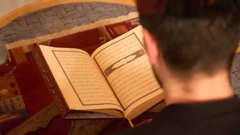 A Muslim man reading the Quran. Man reading the Koran