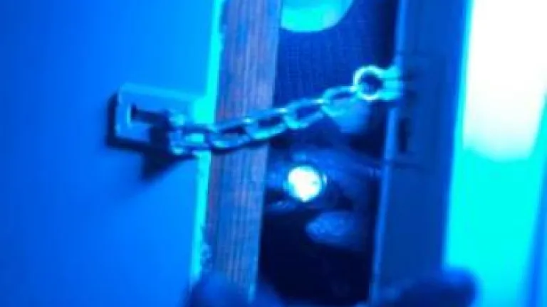 Masked man reaching through door with glove - Did a Good God Create an Evil Worl