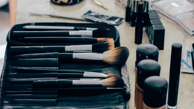 Personal grooming can and often does reflect one's attitude, as we see amply demonstrated in everyday life. Makeup brushes, powder, lipstick on a table.