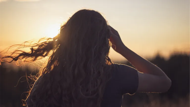 Fasting is a great spiritual tool essential in a true believers' life. A young woman with her hair blowing in the wind.