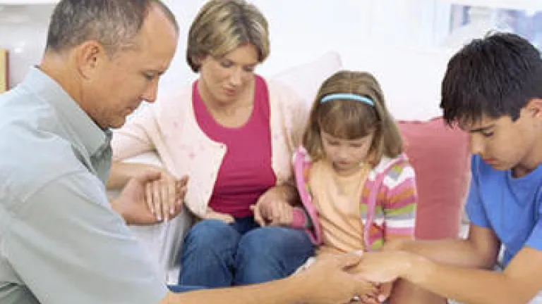 A family praying together.