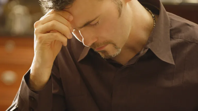 A man praying over his Bible