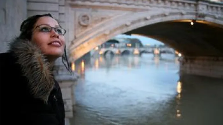 A young woman looking up at the sky.