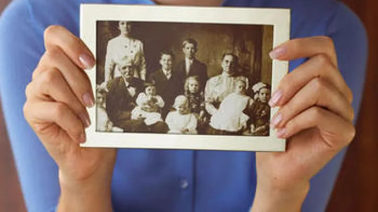 God's Spiritual Family: Will You Be in the Picture? A woman holding an old family photo.