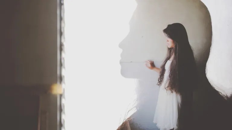 The silhouette of a young woman.