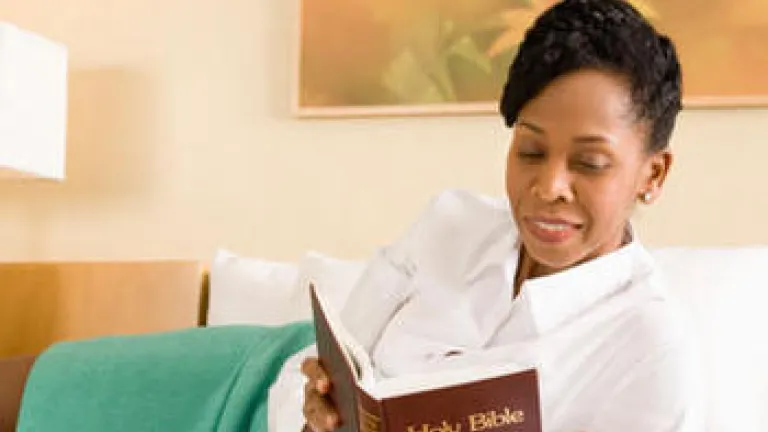 A woman reading a Bible.