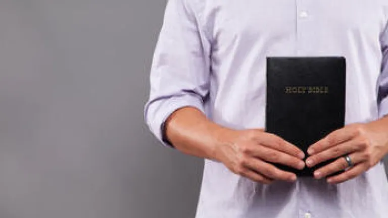 A man holding a Bible.