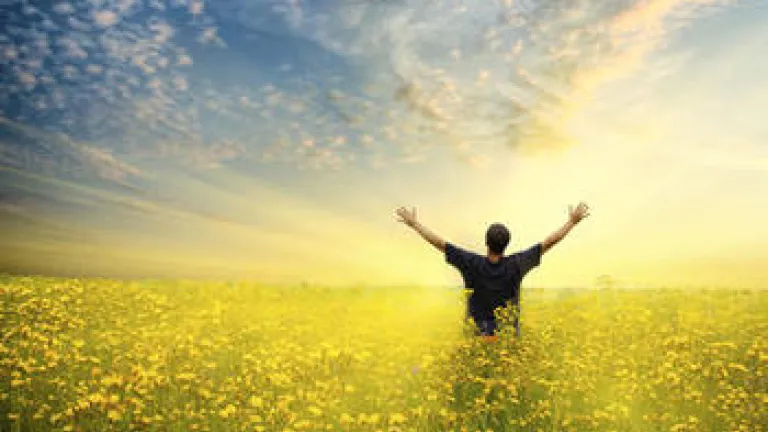 A man raising his hands to the sky.