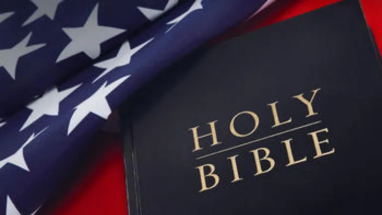 Holy Bible on laying on top of United States flag