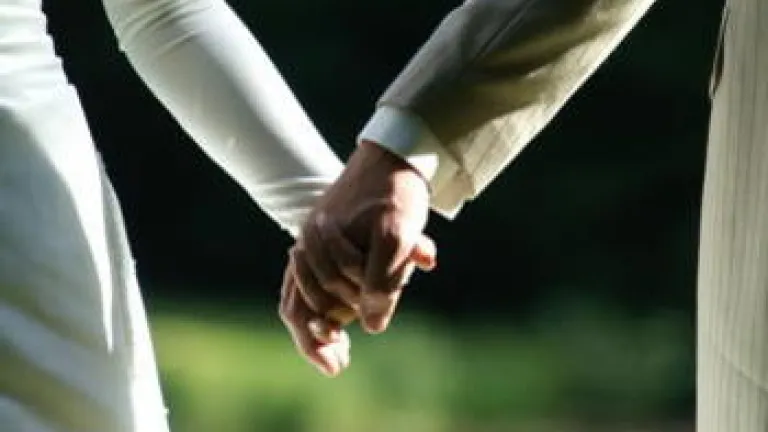 Newly married husband and wife holding hands.