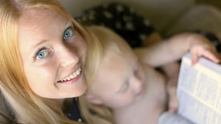 A young mother holding a Bible and reading the Bible.