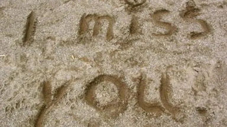 words I miss you written in sand