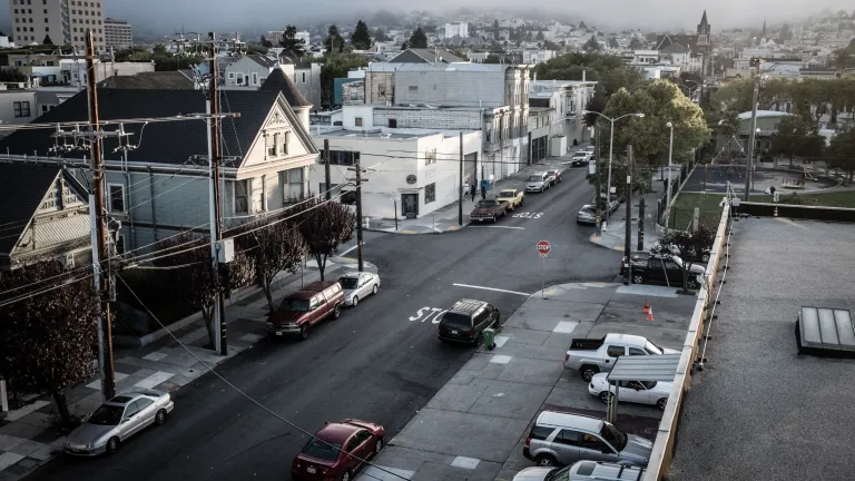 View from the top of building looking down at a city street.