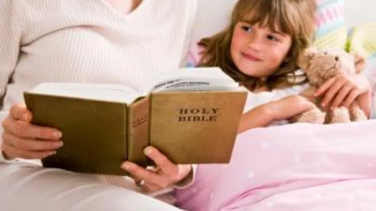 Teaching Youth Religious Values Mother reading Bible to child in bed - Teaching Youth Religious Values