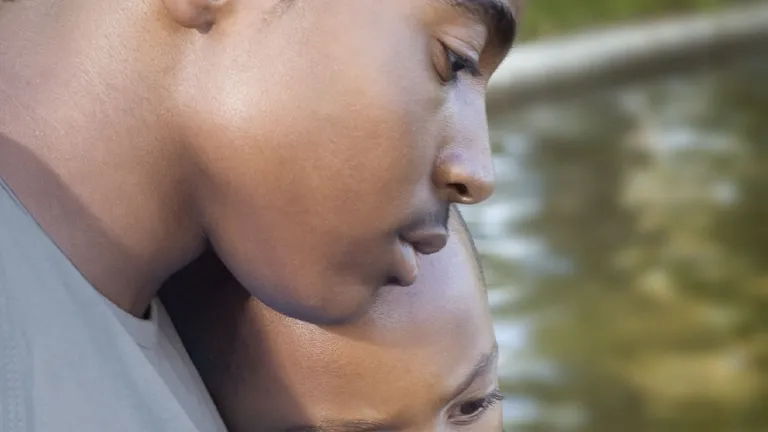 A young man comforting his younger brother.