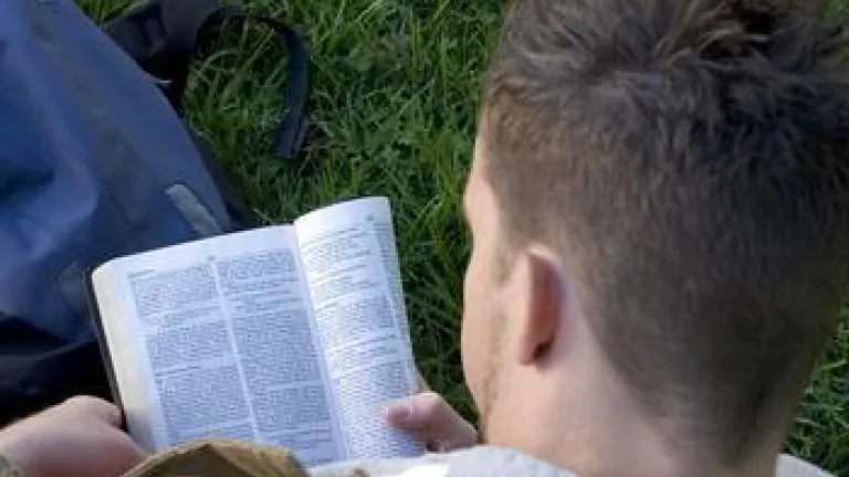 Young man reading a Bible.