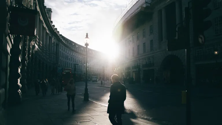 People walking next to a street.