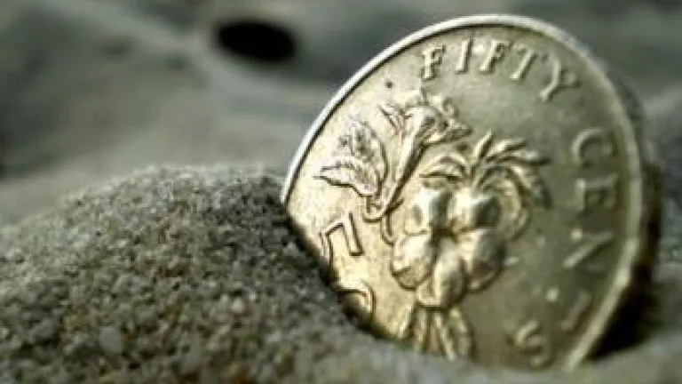 coin buried in sand