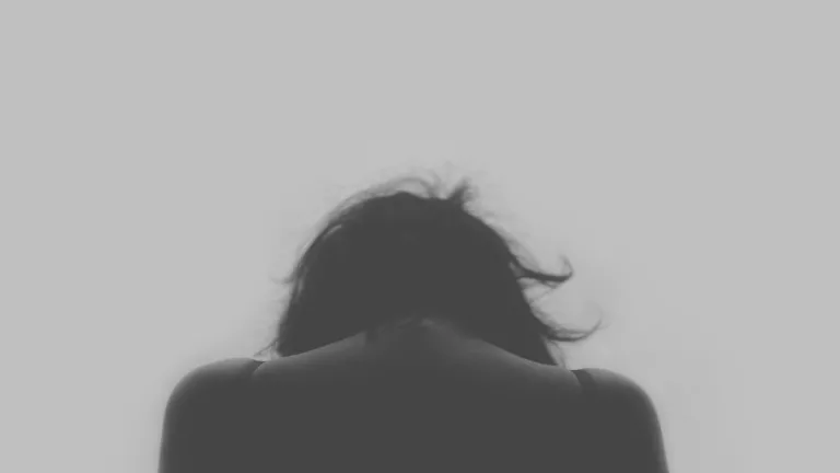 In the world that God is preparing for us, there will be no room for abominations. The back of a woman with her head down.