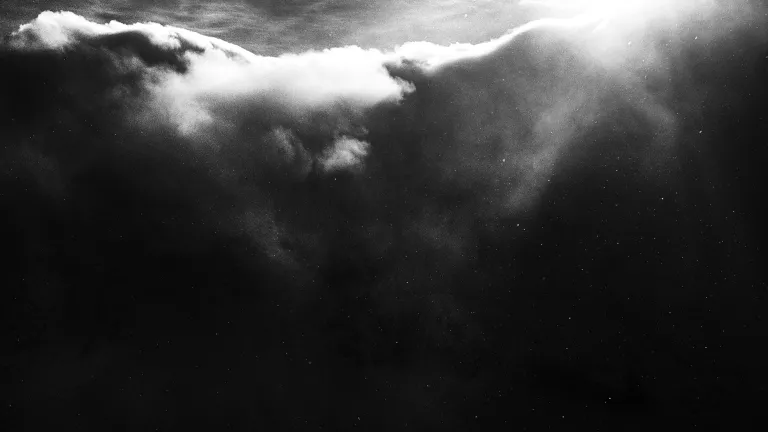Dark clouds with sunlight filtering through.