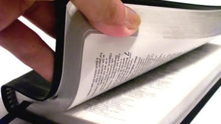 hand opening Bible