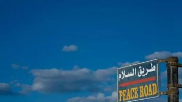 Sky and road sign &quot;peace road&quot; in english - When Will Peace Come to