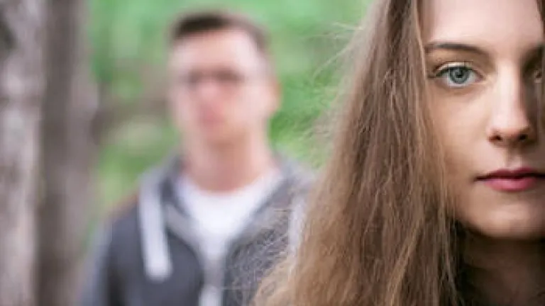 Why Are Young Christians Divorcing? A young couple - woman in the foreground, man in the background blurred.