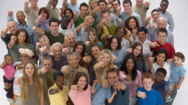 A group of people pointing at the camera.